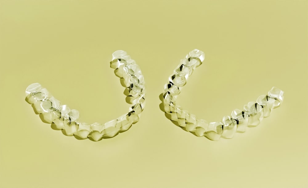 2 clear dentures with sickly background, double clear dentals